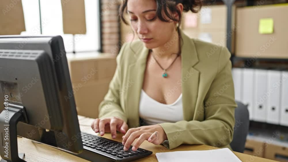 Young beautiful hispanic woman ecommerce business worker using smartphone while work at office