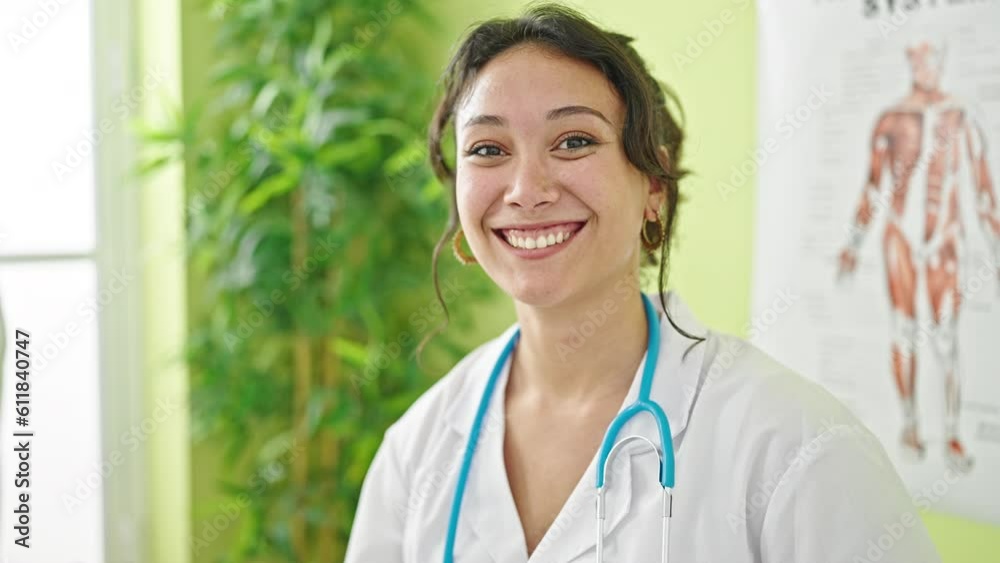 Young beautiful hispanic woman doctor smiling confident standing at clinic Young beautiful hispanic woman doctor smiling confident standing at clinic