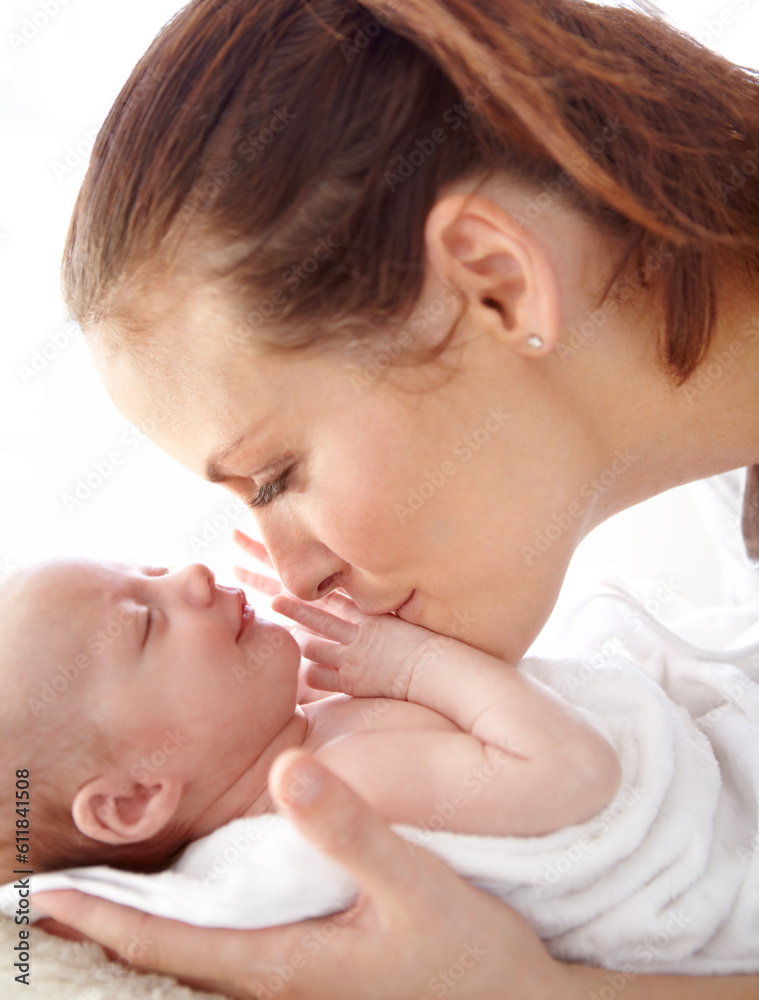 Mother, kiss and newborn baby in closeup with love, happiness and care in bedroom at family home. Young mom, infant child and hug with happy bonding, pride and together on bed in morning at house Mother, kiss and newborn baby in closeup with love, happiness and care in bedroom at family home. Young mom, infant child and hug with happy bonding, pride and together on bed in morning at house