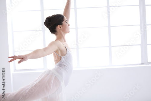 Dance, ballet and window with woman in studio for balance, elegant and performance. Artist, theatre and training with female ballerina dancing in class for competition, freedom and commitment