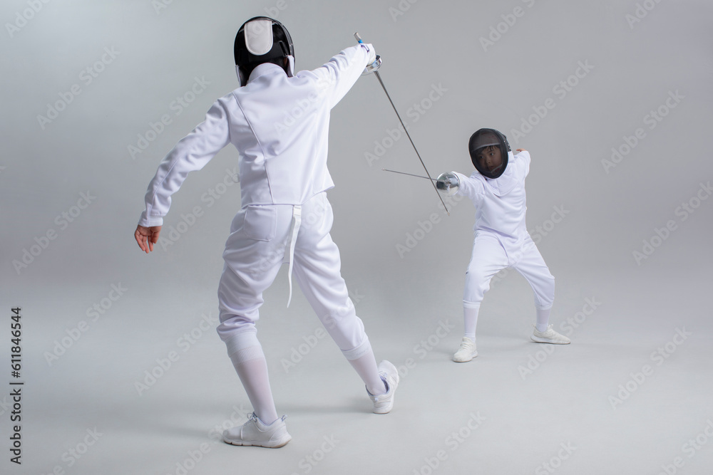 Cute boys in fencing suit