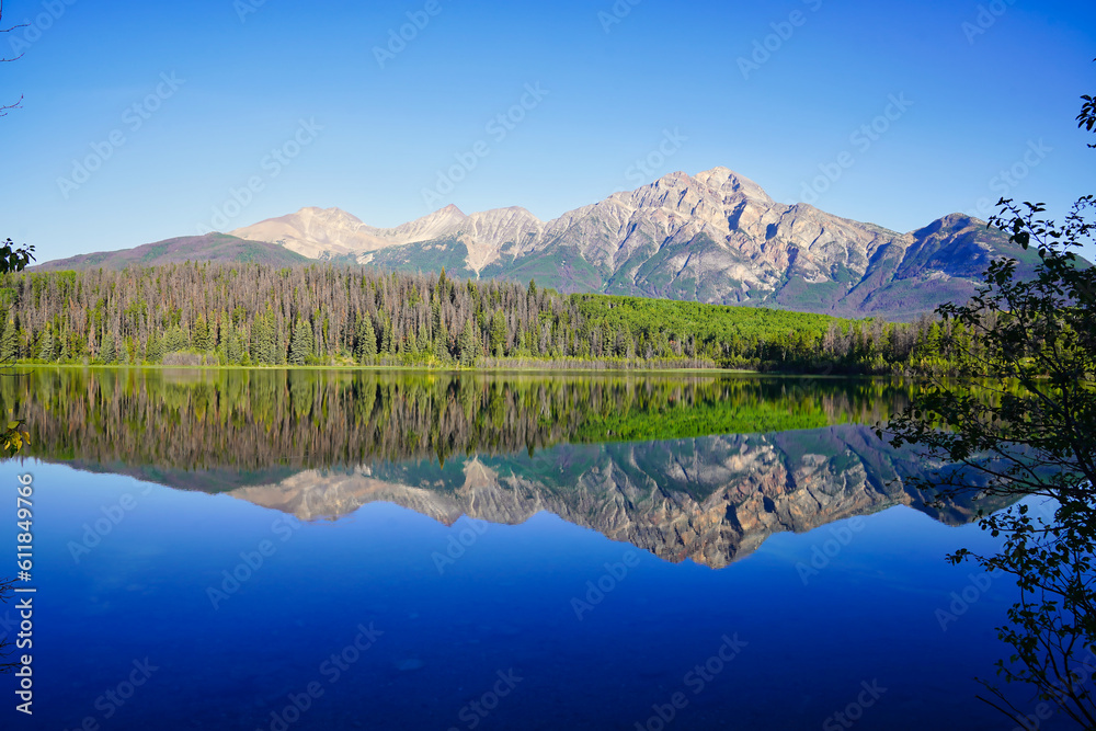 Pyramid Mountain reflected in the early morning, still, glass like waters of the stunning Patricia Lake near Jasper in the Canada rockies