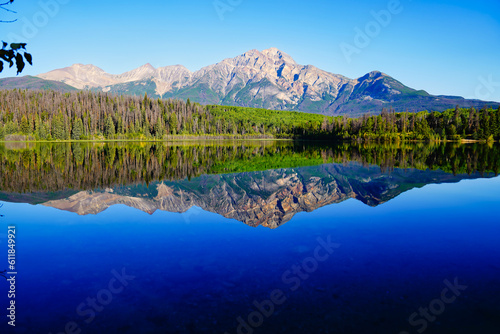 Pyramid Mountain reflected in the early morning  still  glass like waters of the stunning Patricia Lake near Jasper in the Canada rockies
