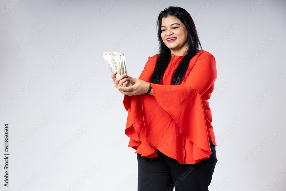 Indian woman showing five hundred bank note on white background. Indian woman showing five hundred bank note on white background.