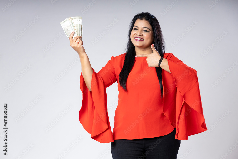 Indian woman showing five hundred bank note on white background. Indian woman showing five hundred bank note on white background.