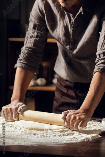 Midsection of chef making noodles