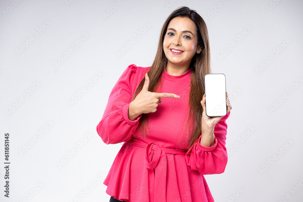 Indian woman showing smartphone screen on white background.