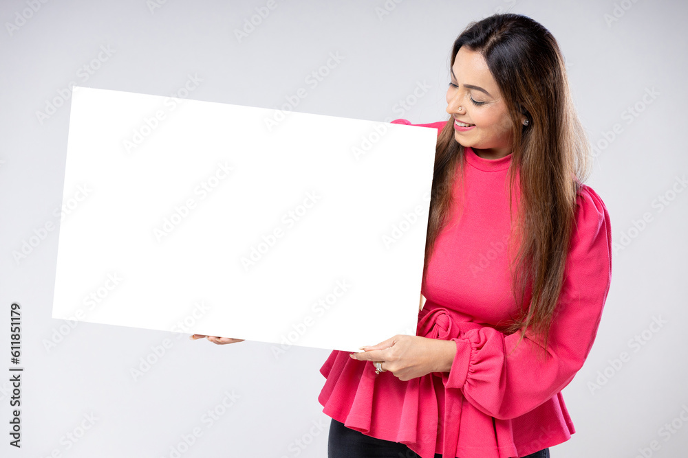 Indian woman showing blank white board. Indian woman showing blank white board.