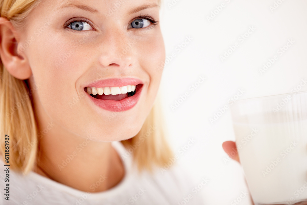 Portrait, milk and happy with a woman drinking from a glass in studio isolated on a white background. Smile, nutrition or calcium with a healthy young female enjoying a drink for vitamins or minerals Portrait, milk and happy with a woman drinking from a glass in studio isolated on a white background. Smile, nutrition or calcium with a healthy young female enjoying a drink for vitamins or minerals