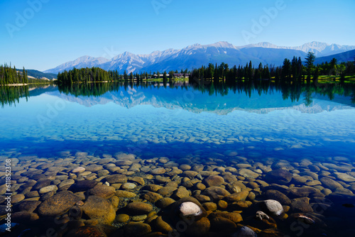 Glassy  transparent blue waters of Lake Beauvert near Jasper in the Canada Rockies