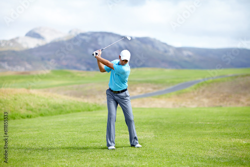 Fitness, man or golfer playing golf for fitness, workout or exercise with a swing on a green course. Wellness, person golfing or athlete training in action or sports game driving with a club stroke