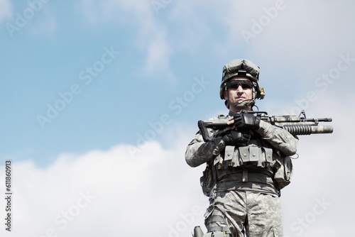 Soldier man, machine gun and outdoor portrait by sky background for mockup space in war, fight or army. Military service, battlefield and agent with weapon, gear or sunglasses for conflict in Ukraine