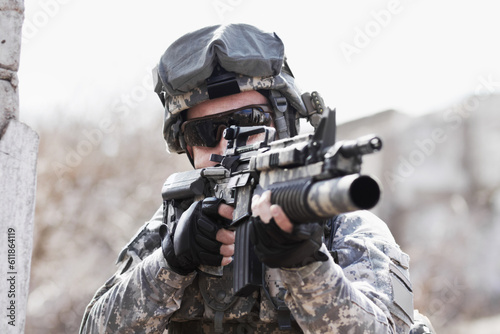 War, training and man with gun in the army for a target, service or a mission. Military, hero and a soldier with a rifle on the battlefield for shooting, danger or violence with a firearm for defense