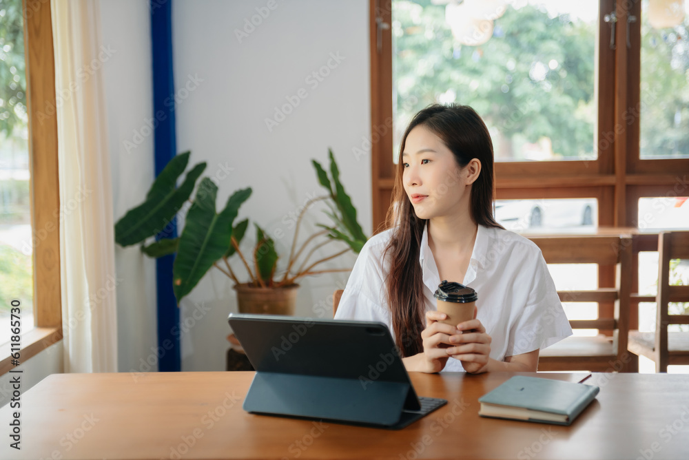 Young attractive Asian female office worker business suits smiling on desk in home office Young attractive Asian female office worker business suits smiling on desk in home office