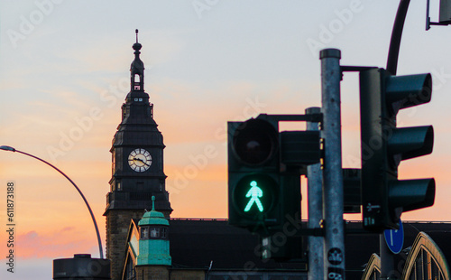 traffic light with green light and safe to move ( Pedestrian Traffic Lights ) Sunset and train station on Hamburg, Germany in the background photo