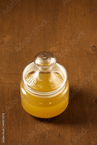 A glass jar with Aquafaba on a brown wooden background photo