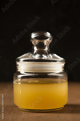 A glass jar with Aquafaba on a brown background photo