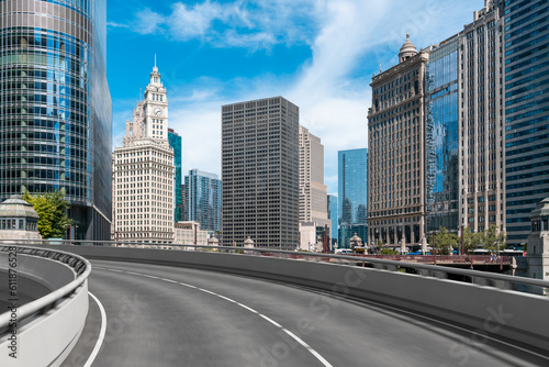 Empty urban asphalt road exterior with city buildings background. New modern highway concrete construction. Concept of way to success. Transportation logistic industry fast delivery. Chicago. USA.