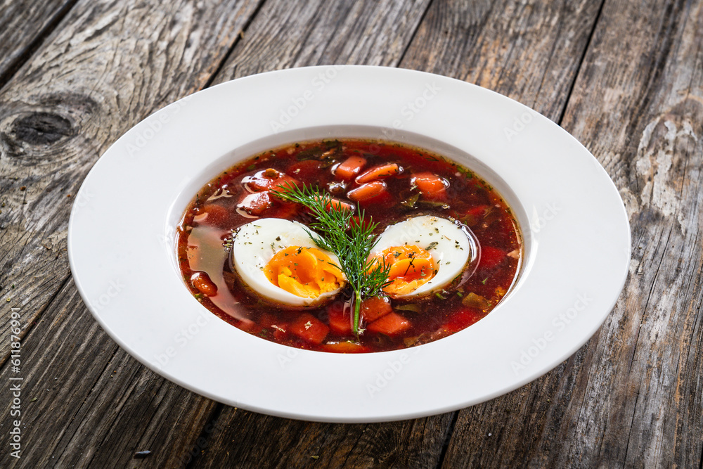 Red borsch - beetroots soup on wooden table Red borsch - beetroots soup on wooden table