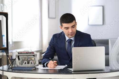 Male bank manager working w...