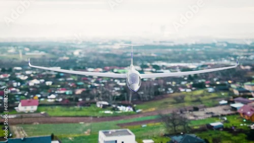 A person is gliding over the town in a sailplane