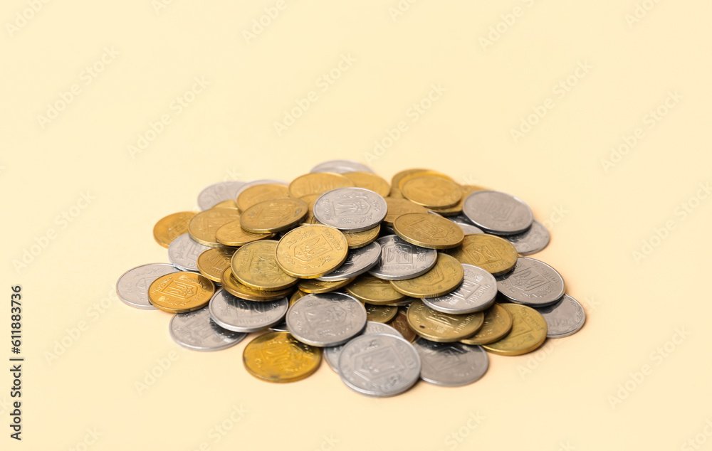 Heap of coins on beige background Heap of coins on beige background