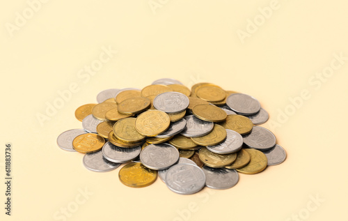 Heap of coins on beige background