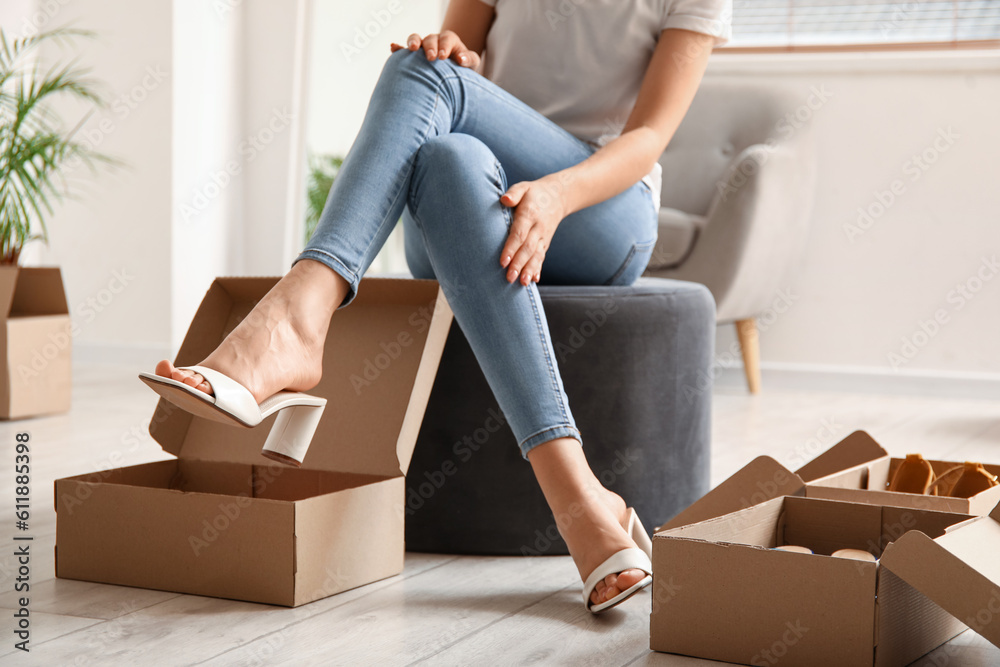 Woman trying on stylish summer shoes in boutique Woman trying on stylish summer shoes in boutique