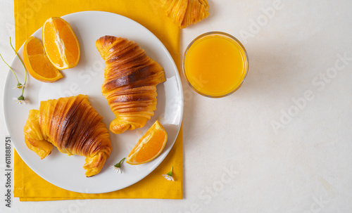 flat lay with Freshly baked portuguese Brioche croissants on a plate with orange juice and chocolate milk. Tipical portuguese breackfast photo