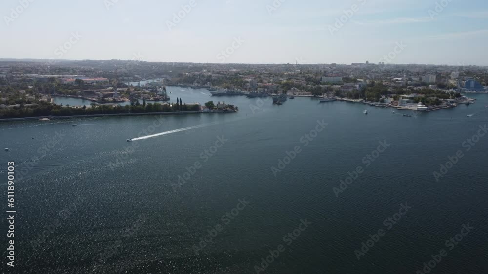 Sea bays of Sevastopol in Crimea during summertime in sunny weather. The aerial drone panoramic view an array of ships and boats, seaside tourism and travel destinations. Sea bays of Sevastopol in Crimea during summertime in sunny weather. The aerial drone panoramic view an array of ships and boats, seaside tourism and travel destinations.