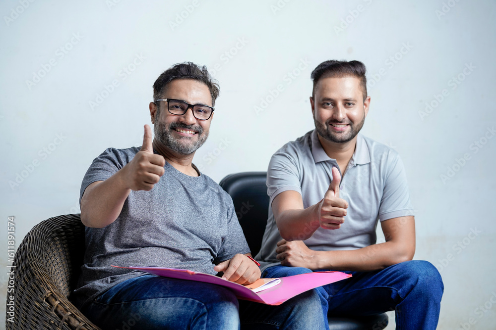 Fototapeta premium Two indian man showing thumps up on white background