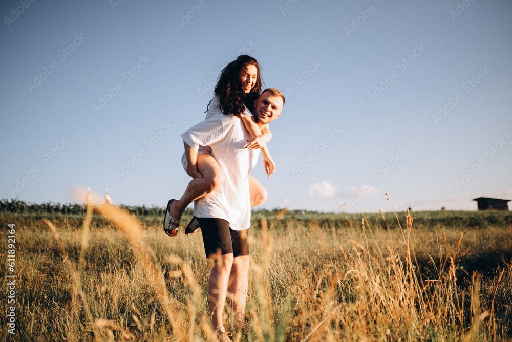 young couple walking at sunset near the river