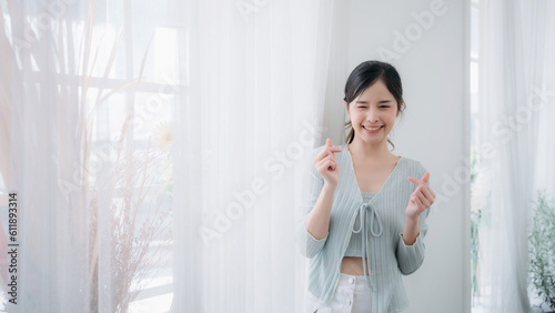 Portrait of young asian woman looking at camera. Beautiful girl with pleasant smile and happy. Cute woman standing and laughing.