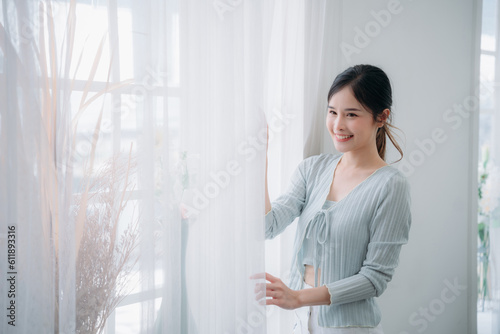 Free Download Portrait of young asian woman looking at camera. Beautiful girl with pleasant smile and happy. Cute woman standing and laughing. - GFXLoad