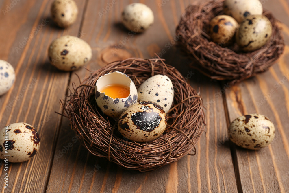 Nest with fresh quail eggs on wooden background Nest with fresh quail eggs on wooden background