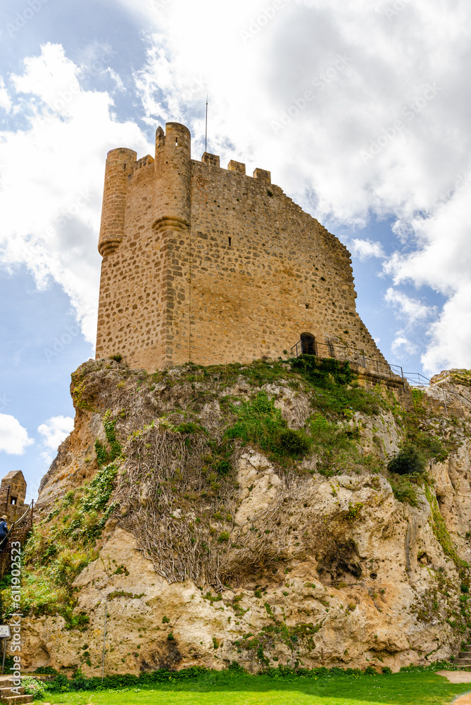Beautiful castle tower from below in Frias castle - fortress in Spain. Ancient gothic castle garrison of the town below. Park with a tree