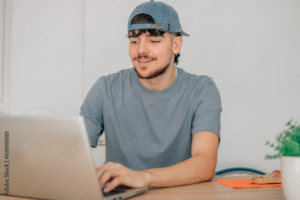 young man at desk with computer young man at desk with computer