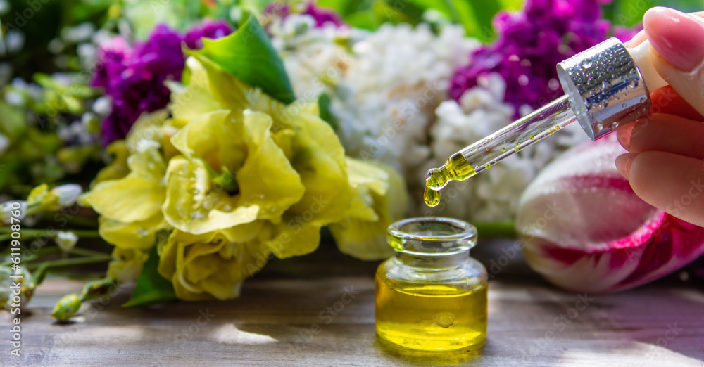 essential oil of flowers drips into a jar. selective focus. essential oil of flowers drips into a jar. selective focus.