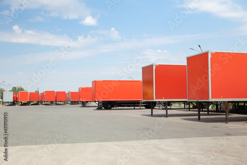 Row of transport truck trailers in a yard photo