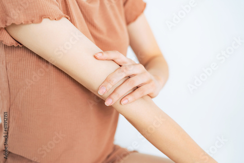Close-up of a woman doing arm skin care. Body care. Self treatment. photo