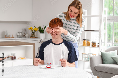 Young woman proposing to he...