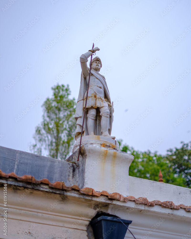 Fototapeta premium Porto, Portugal - 2023. Little statue on a roof.