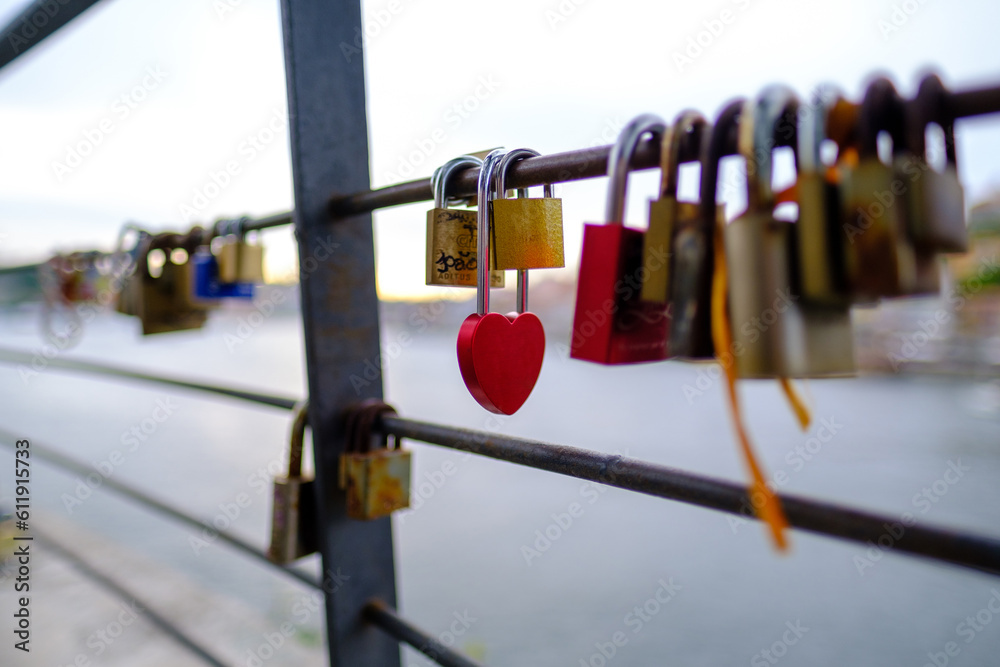 Love padlock with others padlocks locked on a fence in Porto / Vila Nova de Gaia, Portugal - 2023.