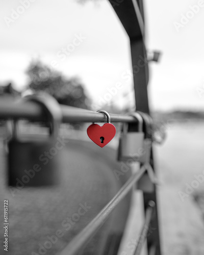 Red love padlock in a black and white photo. Porto / Vila Nova de Gaia, Portugal - 2023.