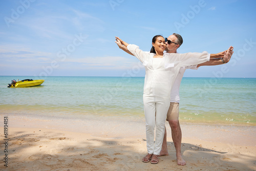 couple hugging and kissing on the beach