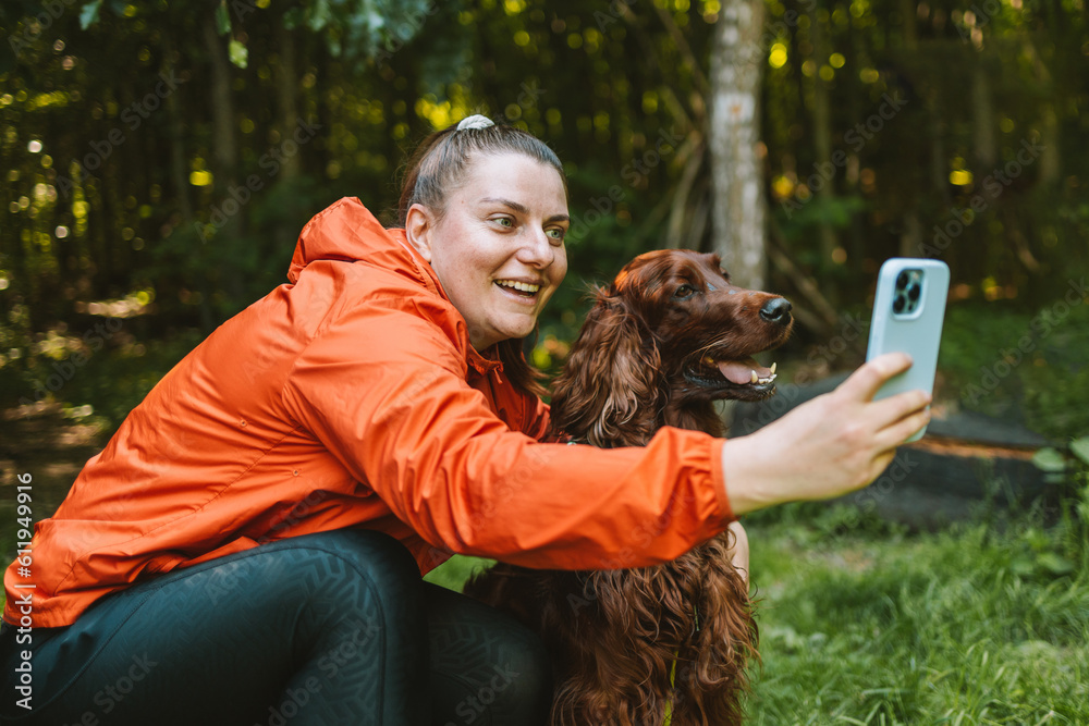 Happy caucasian girl hiker hiker takes a selfie with her cute Irish ...
