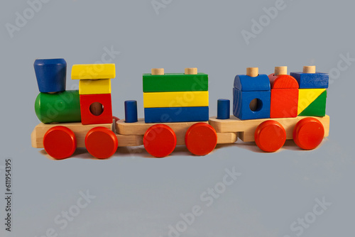 Children's wooden steam train with wagons on a blue background