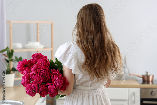 Young woman with bouquet of...