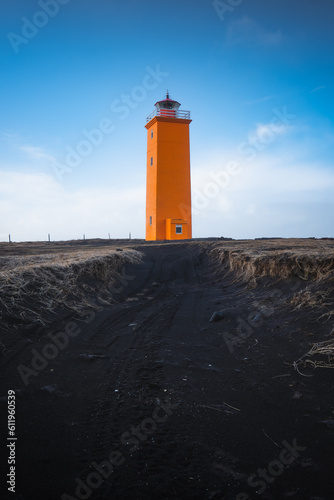 orange icelandic lighthouse view with beutiful clouds