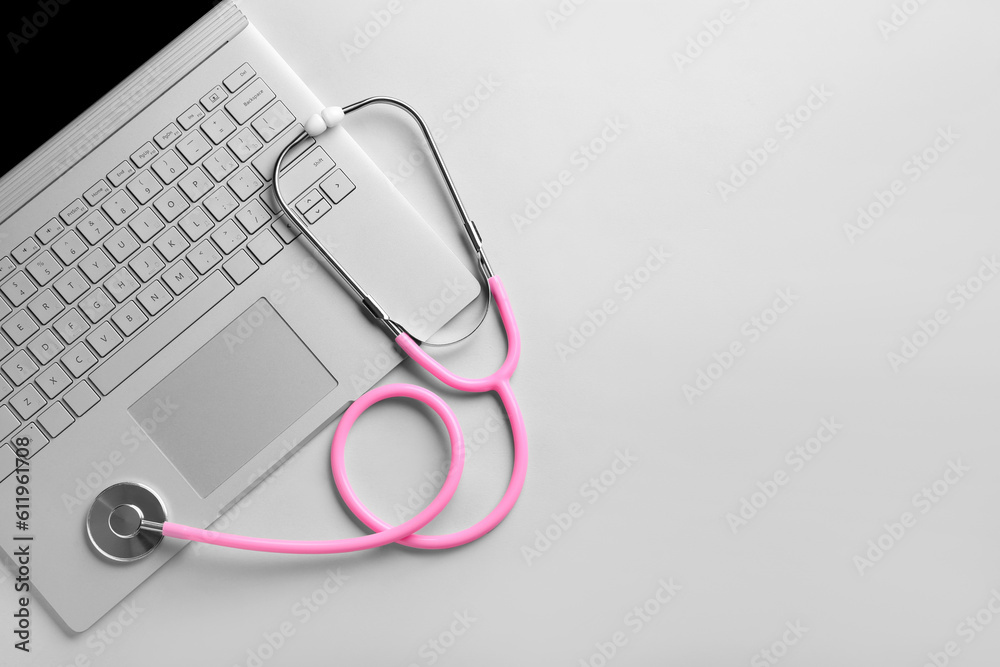 Stethoscope and laptop on light background, top view Stethoscope and laptop on light background, top view